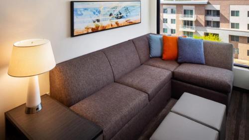a living room with a couch and a lamp at Hyatt Place Scottsdale North in Scottsdale