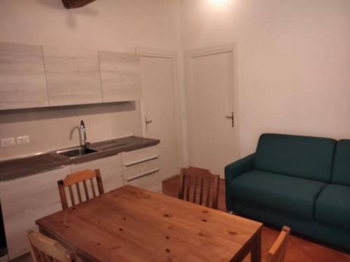 a living room with a table and a blue couch at Casa dell'Arco 31 in Camogli