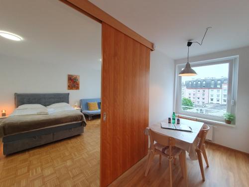 a bedroom with a bed and a table and a window at Apartment Zala with free parking Tour As Ljubljana in Ljubljana