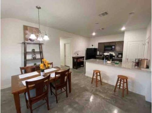 a kitchen and dining room with a table and chairs at Fully Furnished with Full Kitchen Appliances, 3 Bedroom and 2 Bath Home in Killeen