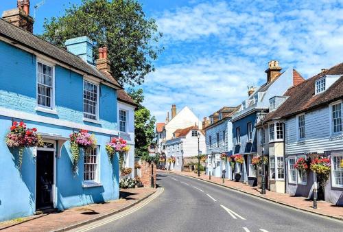 a street in a town with blue and white houses at Bexhill Old Town Retreat in Bexhill