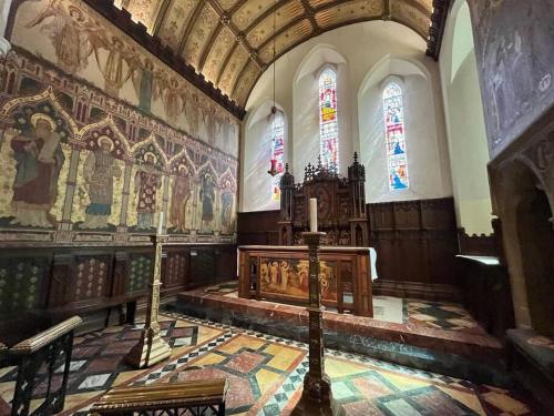 a church with a altar and stained glass windows at Bexhill Old Town Retreat in Bexhill