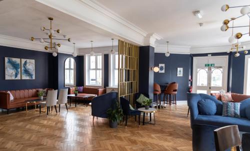 a living room with blue walls and furniture at Hamlet Hotels Maidstone in Maidstone