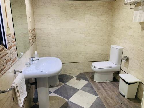a bathroom with a sink and a toilet at HOSTAL HENARES in San Fernando de Henares