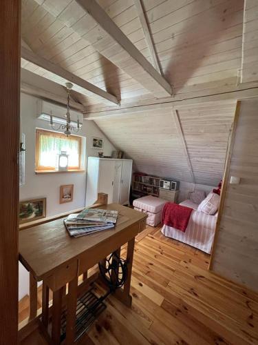a room with a wooden table in a house at Dom pod kogutem in Laliki