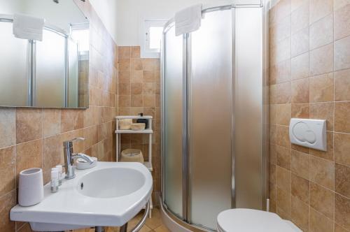 a bathroom with a sink and a shower at Settignano Quiet Apartment with Private Parking in Settignano