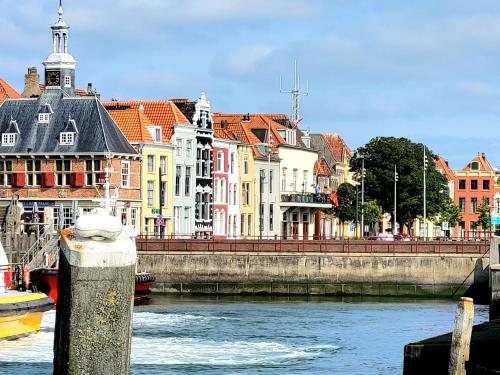 a group of buildings on the side of a river at Rijksmonument Havenzicht, met zeezicht, ligging direct aan zee en centrum in Vlissingen