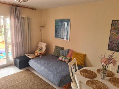 a bedroom with a bed and a table and chairs at Apartamento en Mijas con Terraza, capacidad para 5 personas in Málaga