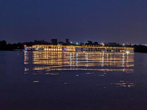 a large boat on the water at night at Sziget festival Apartment next to the river in Budapest