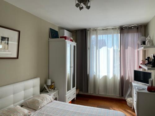 a bedroom with a bed and a large window at Le Patio Père Pigne Guestroom in Perpignan