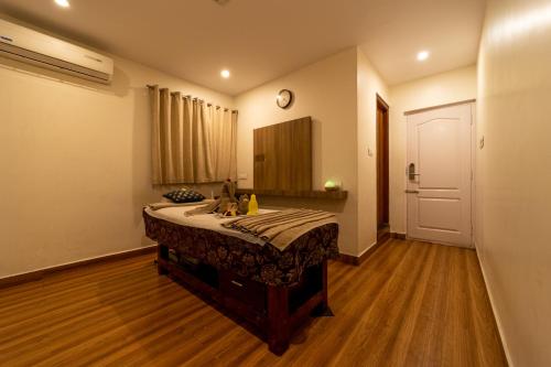 a bedroom with a bed with a sink and a mirror at Tetrad Hotels - International Airport Road Hebbal in Bengaluru