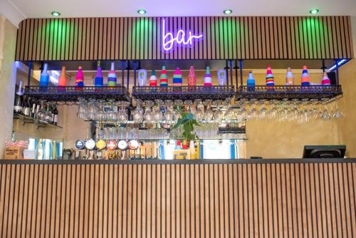 a bar with a bunch of different types of drinks at Revado Hotel in Norwich