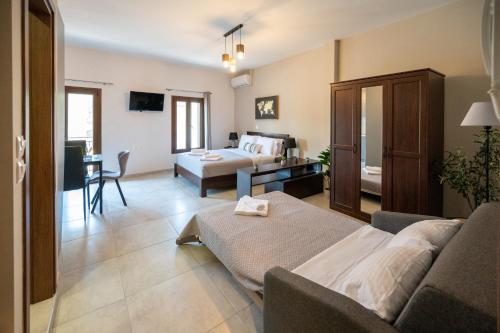 a living room with a couch and a bed at Casa en el Lago -Luxury apartments in the historical center of Ioannina in Ioannina
