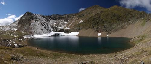 a mountain lake in the middle of a mountain at Schuistlhof in Sillian