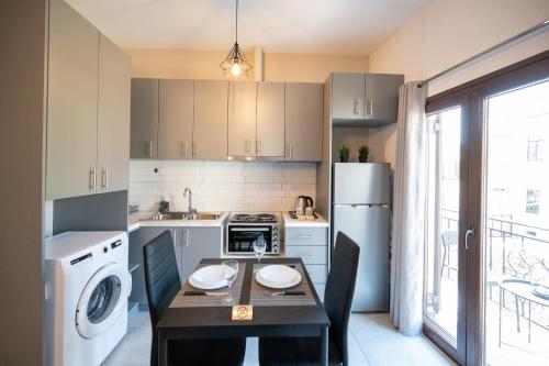 a small kitchen with a table and a refrigerator at Casa en el Lago -Luxury apartments in the historical center of Ioannina in Ioannina