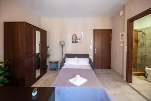 a hotel room with a bed and a bathroom at Casa en el Lago -Luxury apartments in the historical center of Ioannina in Ioannina