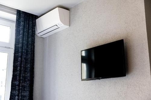 a flat screen tv hanging on a wall at Hotel Bristol in Luxembourg
