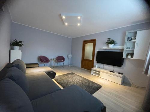 a living room with a couch and a flat screen tv at Casa Teresa in Cluj-Napoca