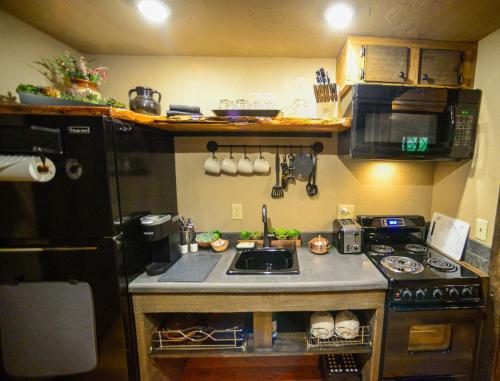 a kitchen with a sink and a stove top oven at Vikings Villages Resort in Guilford