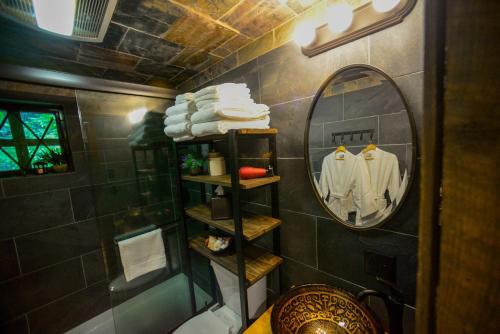 a bathroom with a mirror and a shower with towels at Vikings Villages Resort in Guilford