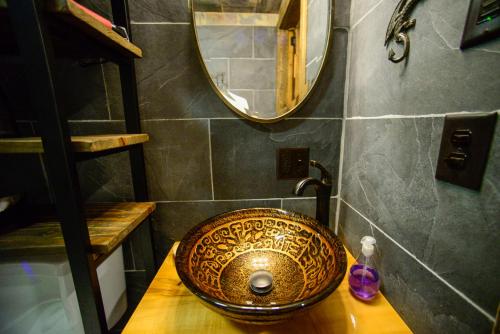 a bathroom with a sink on a wooden table at Vikings Villages Resort in Guilford