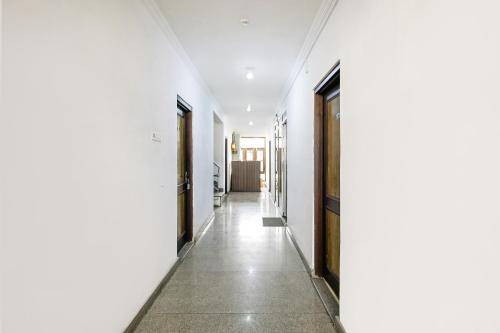 an empty hallway with white walls and doors at City Star Hotel & Restaurant in Jawāharnagar