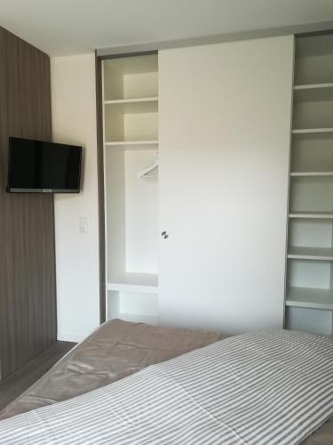 a bedroom with a bed and a flat screen tv at Apart Schleswig in Schleswig