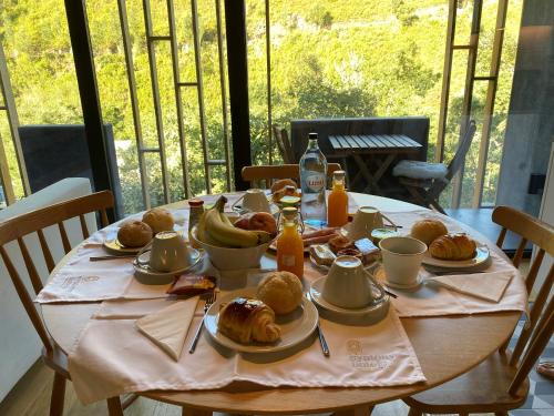 a table with breakfast foods and drinks on it at Syntony Hotels - Paradinha Village in Arouca