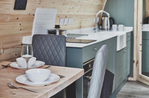 a kitchen with a wooden table with dishes on it at Iona Pods in Iona