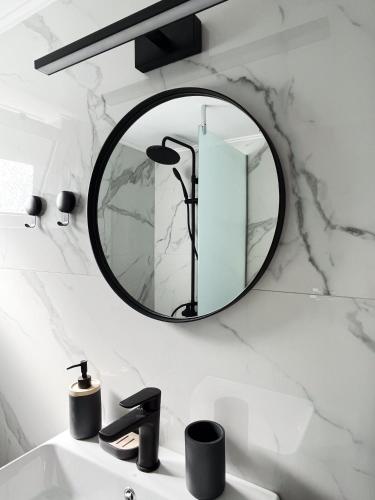 a bathroom with a mirror above a sink at Anna's Apartment in Kato Daratso