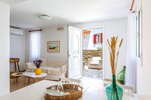 a living room with a couch and a table at Anemologio 301 Tinos in Agios Ioannis Tinos