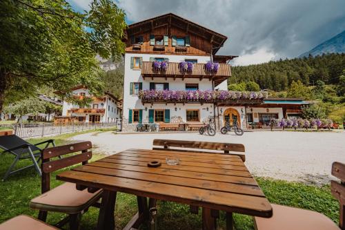 a wooden picnic table in front of a building at Locanda Montana in San Vito di Cadore