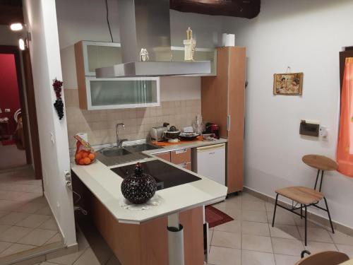 a kitchen with a sink and a counter top at La casetta di nonna Sesa in Viterbo
