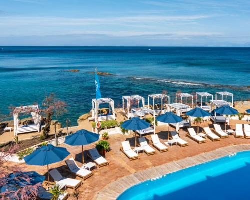 an aerial view of a beach with chairs and umbrellas at Approdo Resort Thalasso Spa in Castellabate