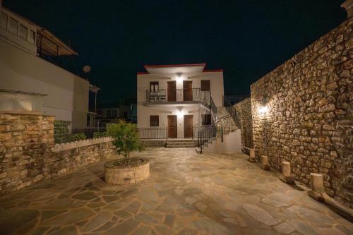 a building at night with a potted plant in front at Casa en el Lago -Luxury apartments in the historical center of Ioannina in Ioannina