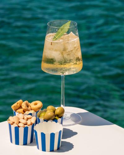 a drink sitting on a table next to the water at Approdo Resort Thalasso Spa in Castellabate