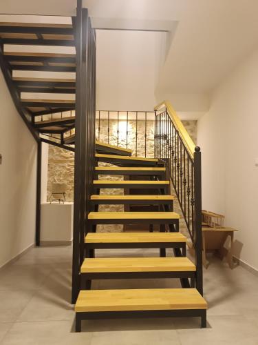 a staircase with wooden risers in a room at Casa en el Lago -Luxury apartments in the historical center of Ioannina in Ioannina