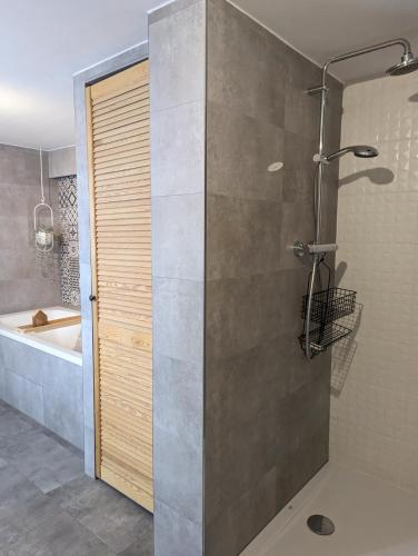 a bathroom with a shower and a bath tub at Ferienhaus Lausitz in Lauta