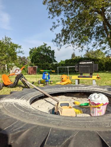 a toy car in the sand in a playground at Ferienhaus Lausitz in Lauta