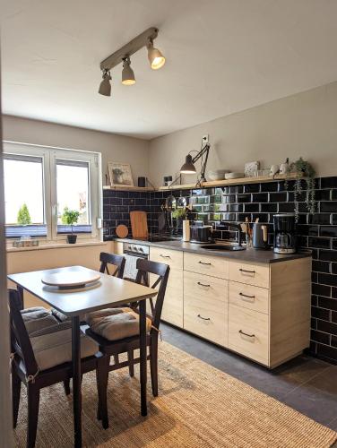 a kitchen with a table and chairs in a room at Ferienhaus Lausitz in Lauta