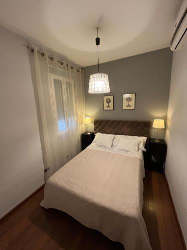 um quarto com uma cama e uma luz pendente em Lavapiés Classy em Madri