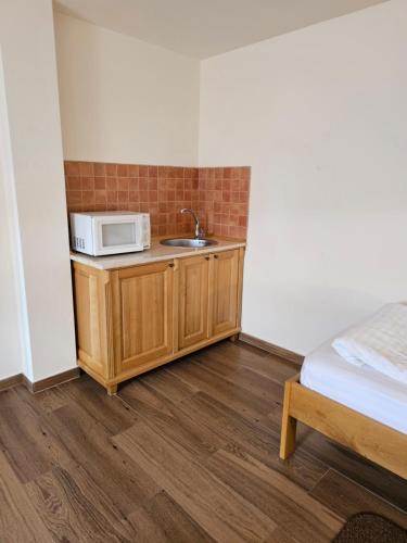 a kitchen with a sink and a microwave on a counter at Pension Aquaris in Sighişoara