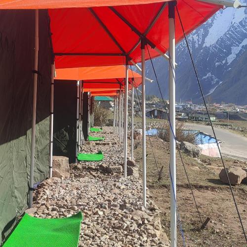 een rij rode en oranje paraplu's op een berg bij Buddy Hikers Stay Badrinath in Badrīnāth