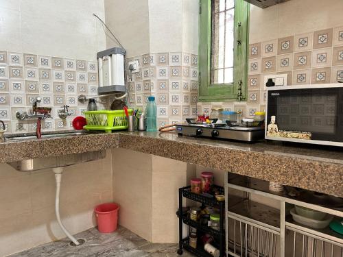 uma cozinha com um lavatório e uma bancada em Cozy Nest - Garden Facing Apartment with Kitchen em Chandīgarh