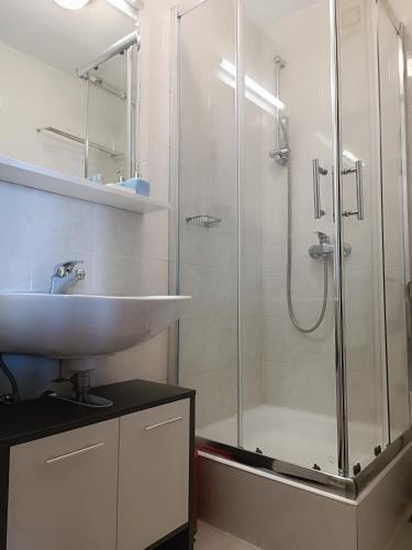 a bathroom with a glass shower and a sink at Rooms Lux in Split