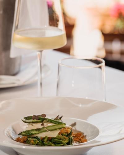 a plate of food and a glass of wine at Approdo Resort Thalasso Spa in Castellabate