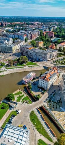 an aerial view of a city with a river and buildings at Great Polonia River Boat Apartments Wrocław in Wrocław