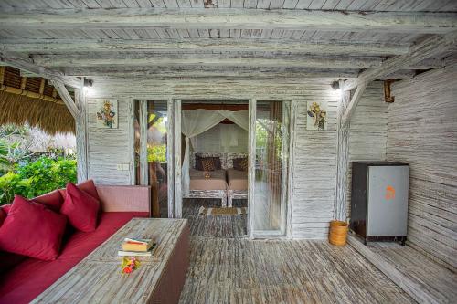 a living room with a couch and a table at Naturale Villas in Nusa Lembongan