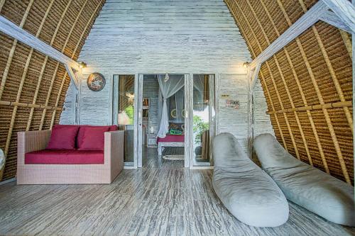 a living room with a couch and a chair at Naturale Villas in Nusa Lembongan