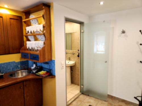 a bathroom with a sink and a toilet and a mirror at Lindos Boutique - Adults Only in Lindos